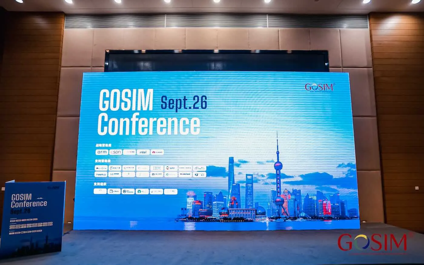 The GOSIM Conference stage, a wide LED screen reading "GOSIM Conference Sept. 26" above a Shanghai skyline illustration and rows of sponsor logos